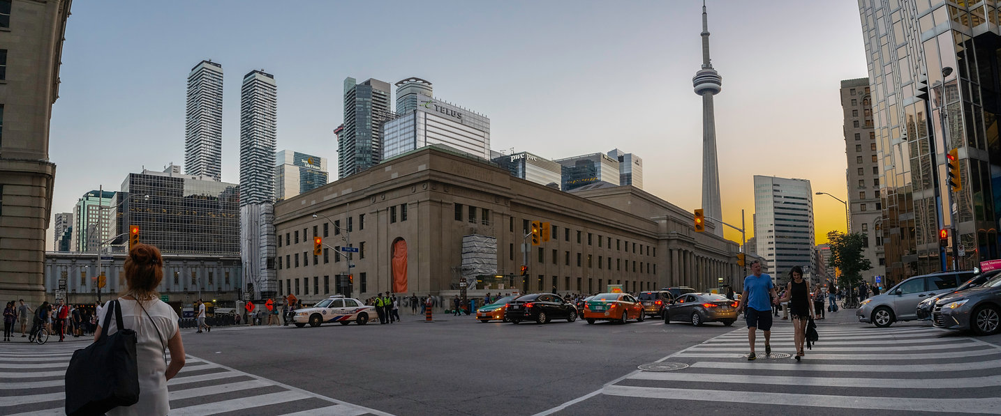Panoramic street-level architecture photograph of downtown Toronto and the CN Tower by Jordan Licon