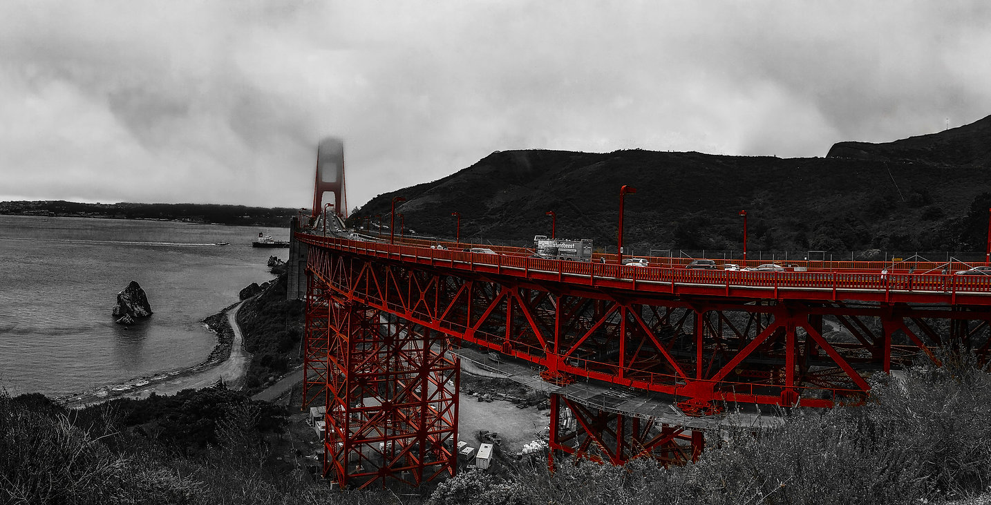 Wide urban architecture photograph of a bridge and waterfront skyline by Jordan Licon
