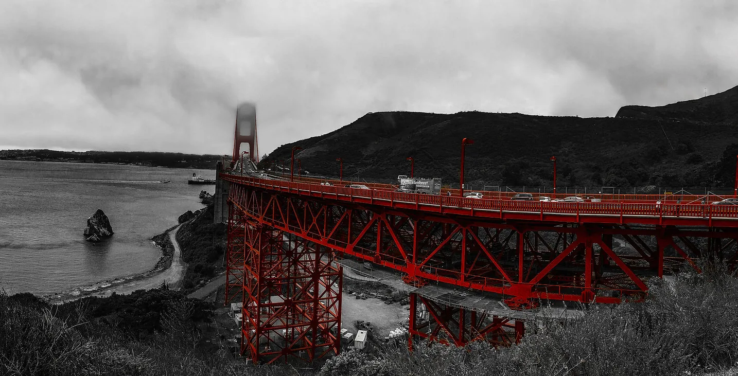 Wide urban architecture photograph of a bridge and waterfront skyline by Jordan Licon