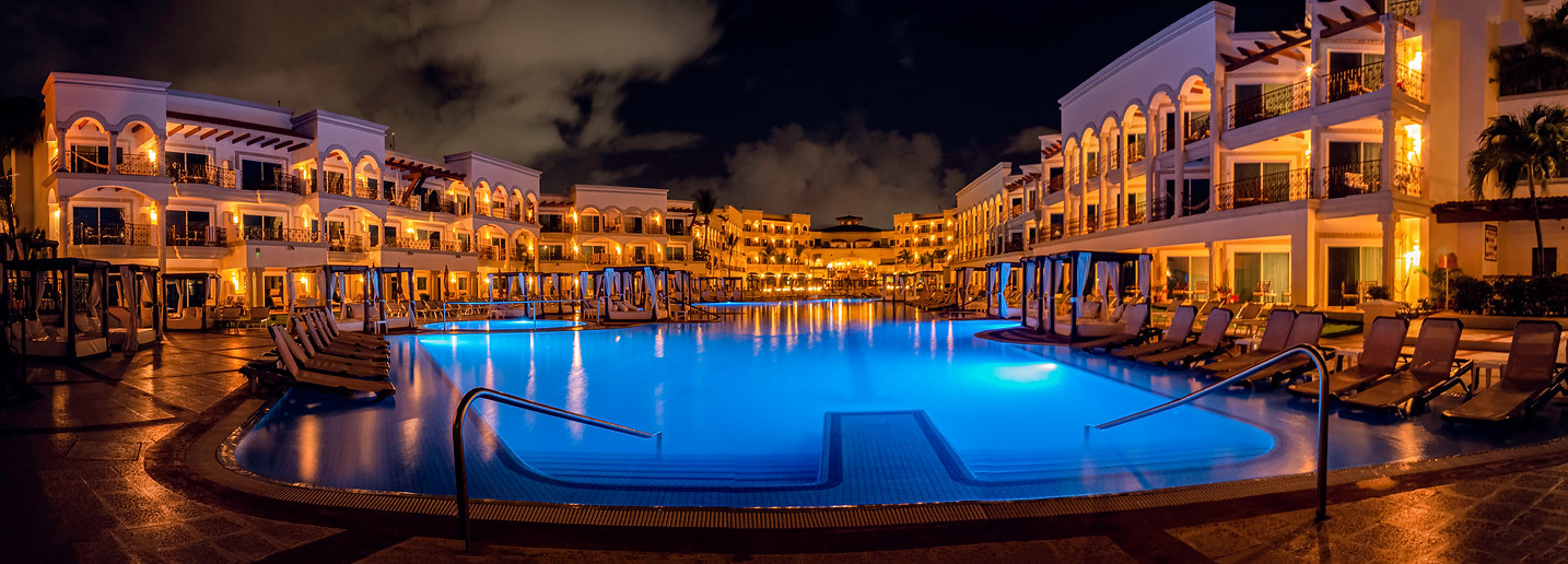 Panoramic resort architecture photograph at night by Jordan Licon