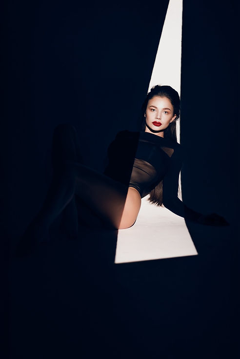 Woman in black fashion portrait, dramatic lighting