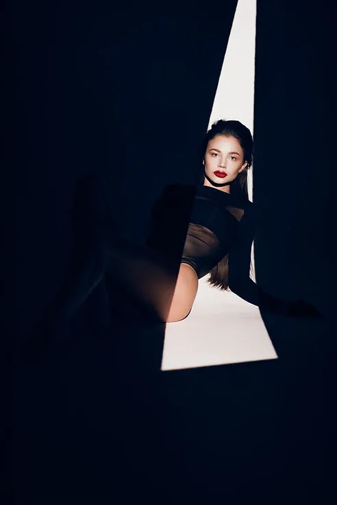 Woman in black fashion portrait, dramatic lighting