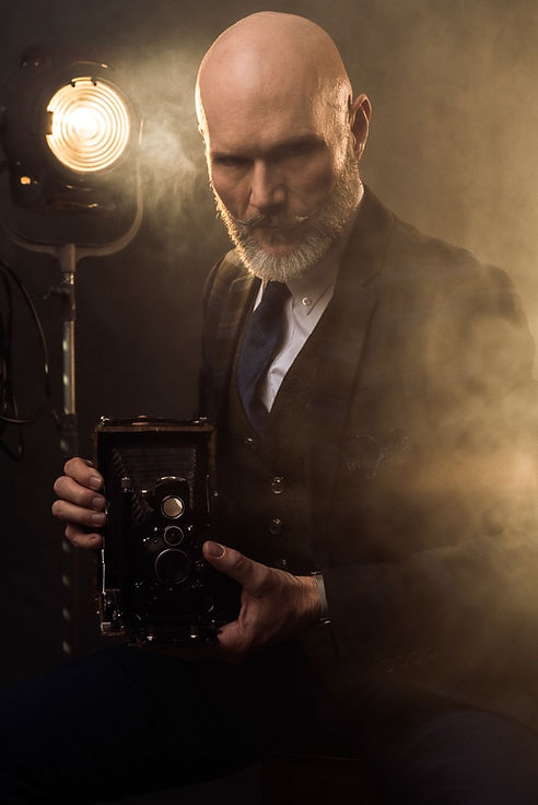 Actor branding portrait with vintage camera and cinematic character direction
