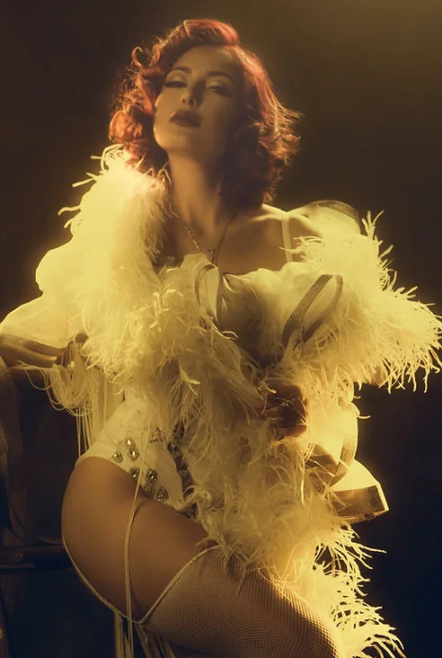 Portrait of a woman in vintage fashion, holding a hand mirror