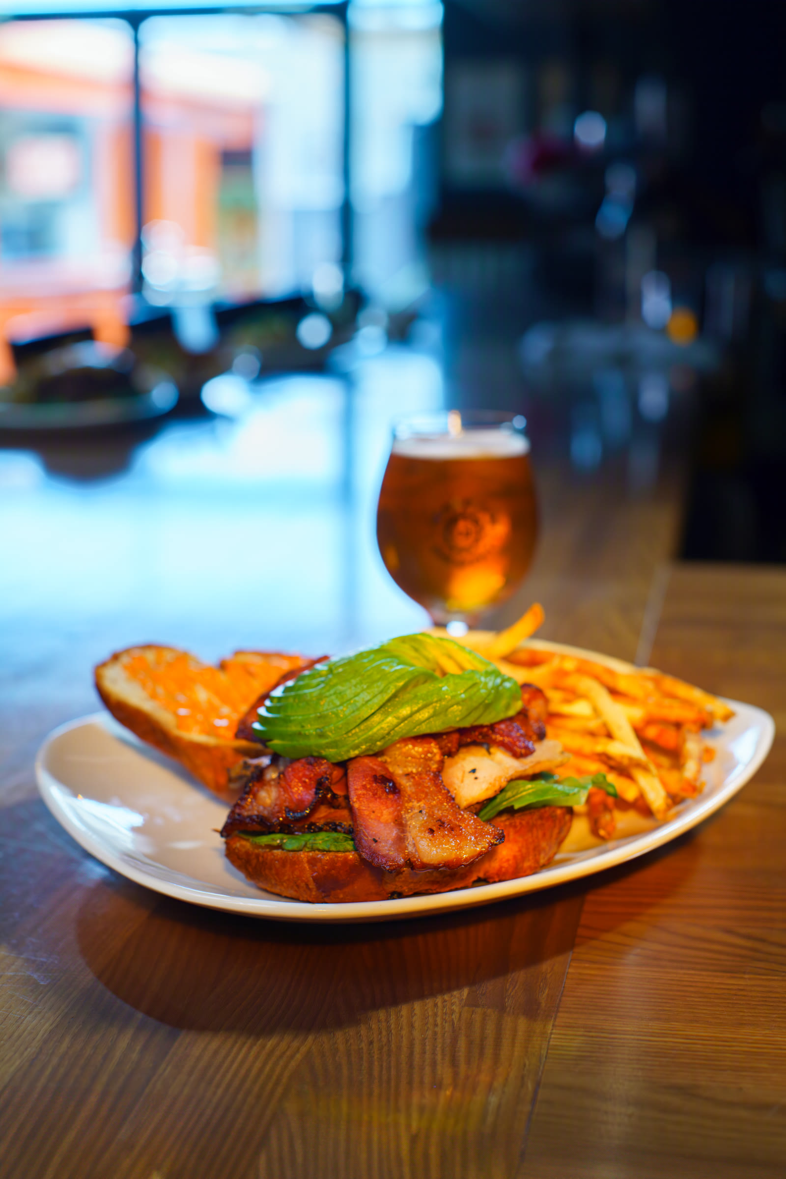 Craft beer and a plated sandwich photographed for a restaurant campaign by Jordan Licon