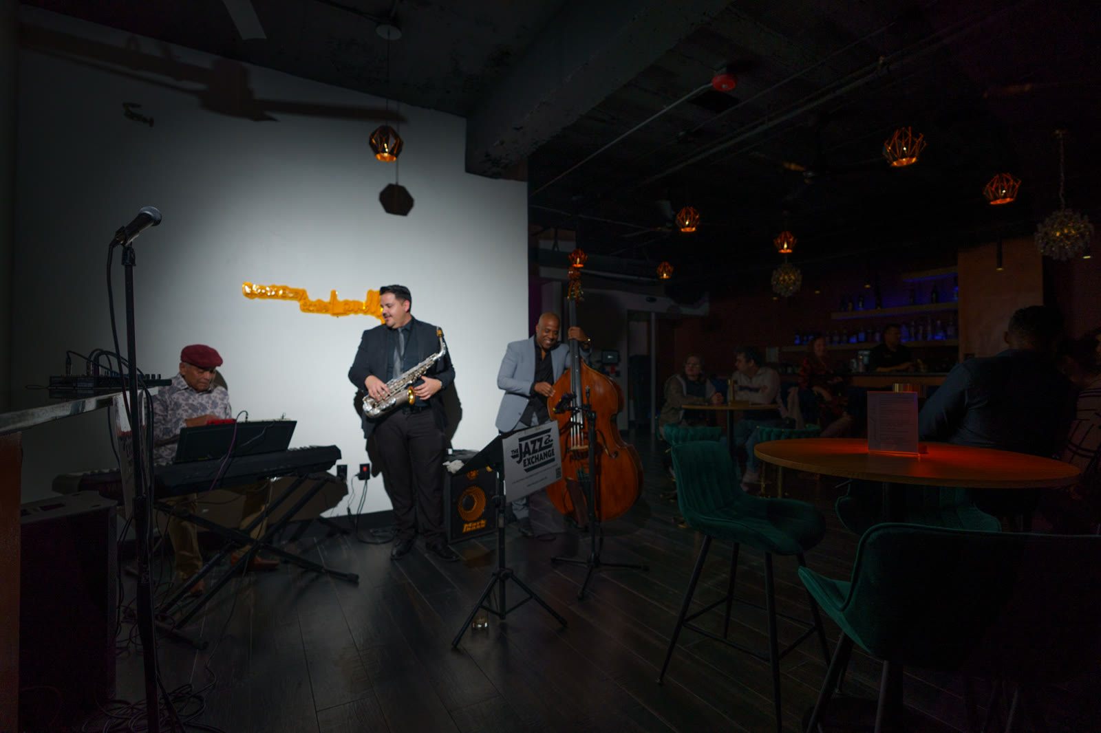 Jazz ensemble and audience photographed during a live performance by Jordan Licon