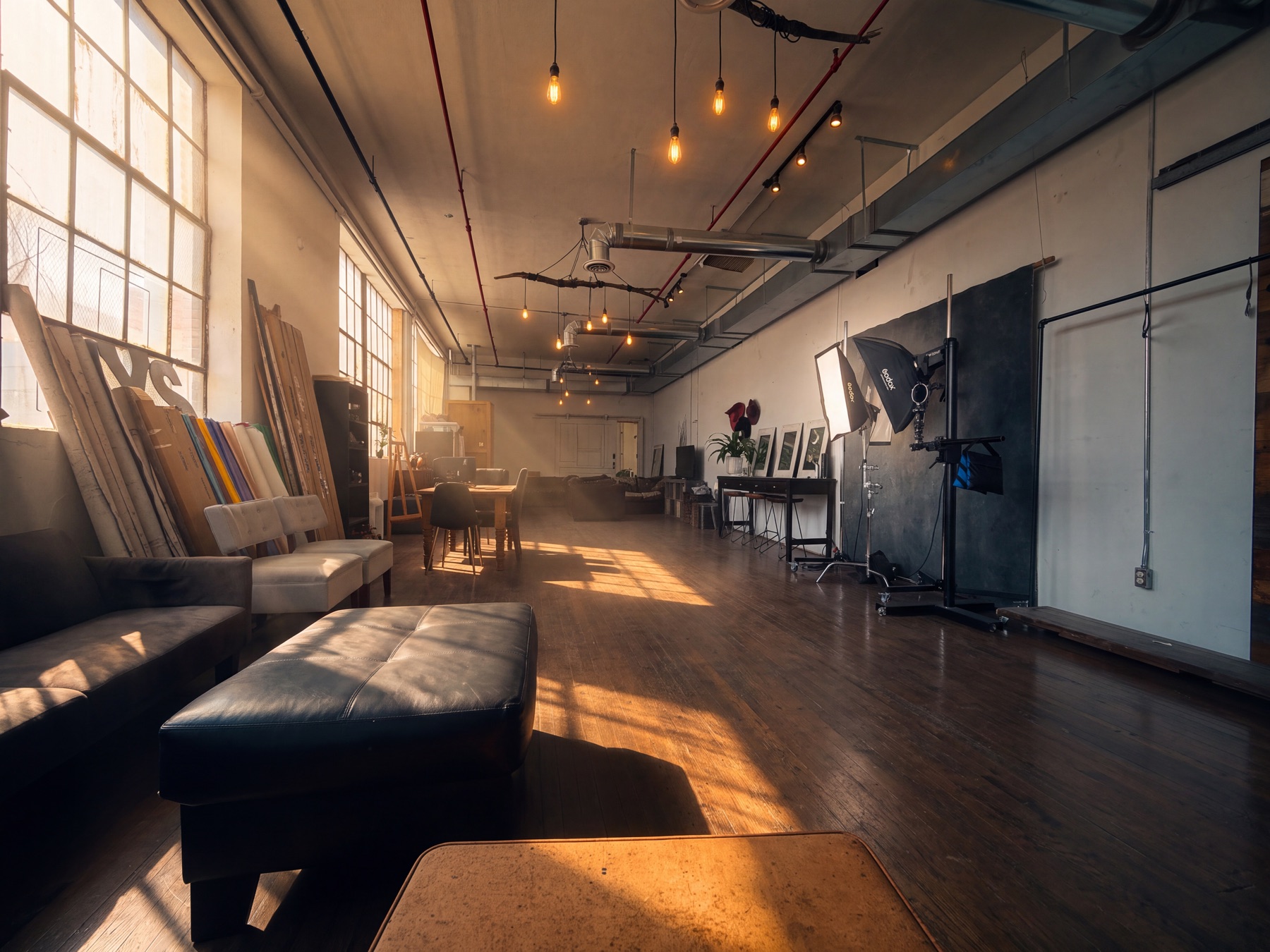 Railyard Studio interior with daylight, brick walls, and portrait lighting equipment